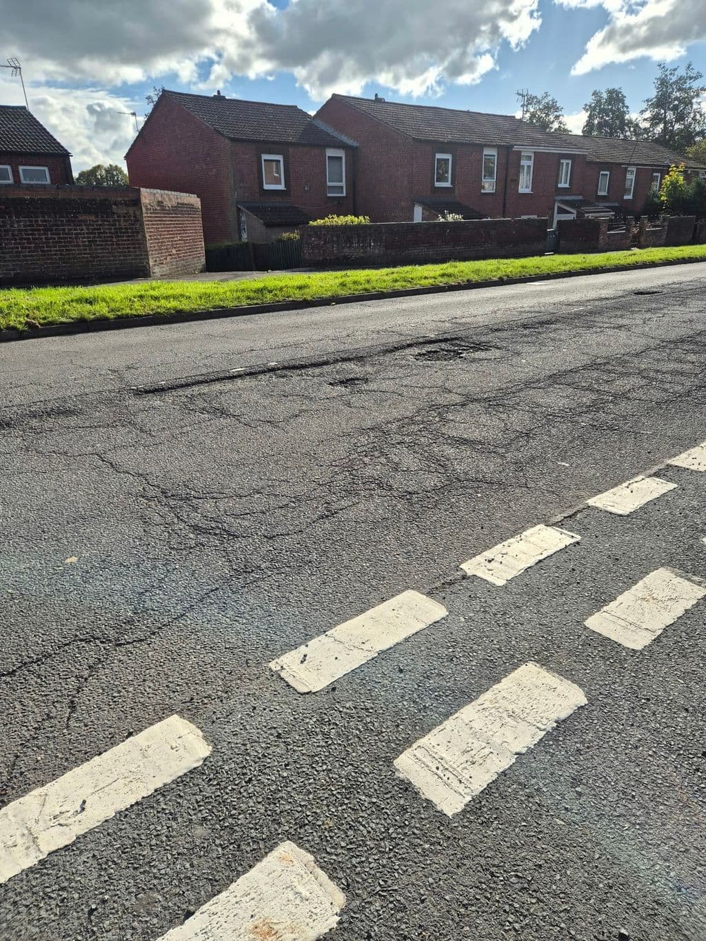 Potholes and failed patch repairs on Boleyn Road, New Frankley